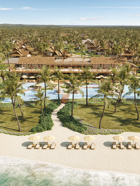 Vista aérea de Salg Patacho Exclusive Resort perfeitamente integrado a um vasto coqueiral nativo. A arquitetura sofisticada com telhados de madeira e materiais naturais circunda uma piscina sinuosa de águas cristalinas. Em primeiro plano, uma praia de areia branca com espreguiçadeiras e guarda-sóis, onde as ondas suaves do mar turquesa.